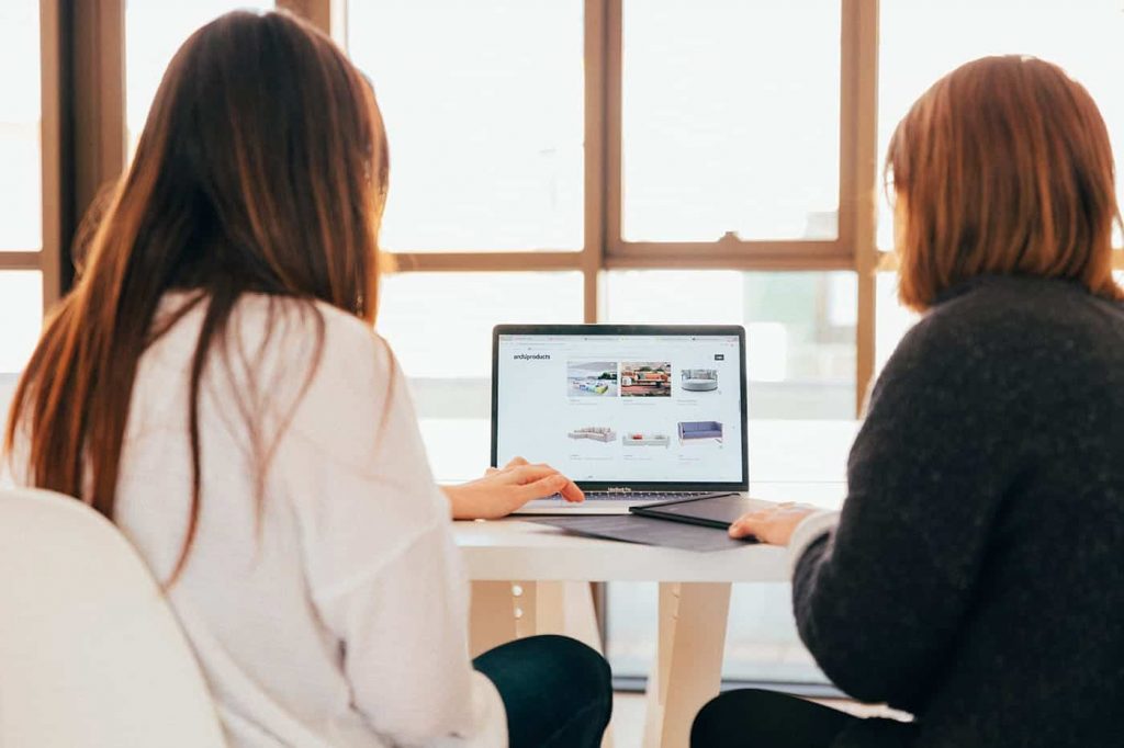 two small business owners working on web design